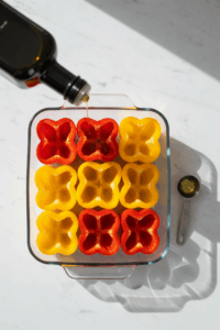 Place pepper halves cut-side up in a baking dish. Drizzle lightly with olive oil.