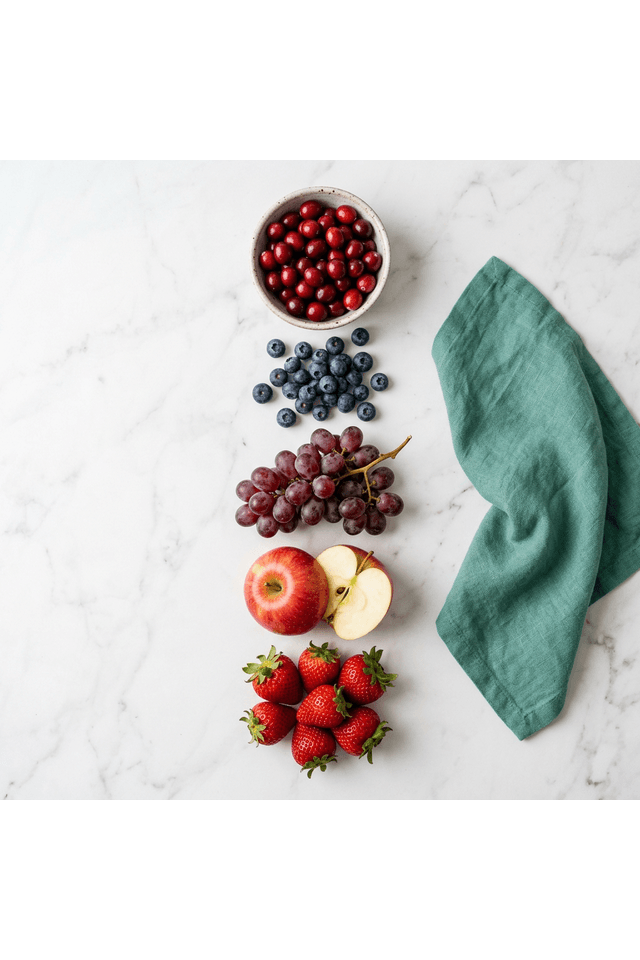 Good fruits for kidneys vertical arrangement — cranberries, blueberries, red grapes, apple, and strawberries kidney-safe green light list