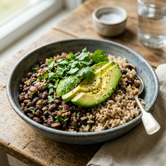 A healthy bowl of black beans and rice with avocado, demonstrating a complete amino acid pairing